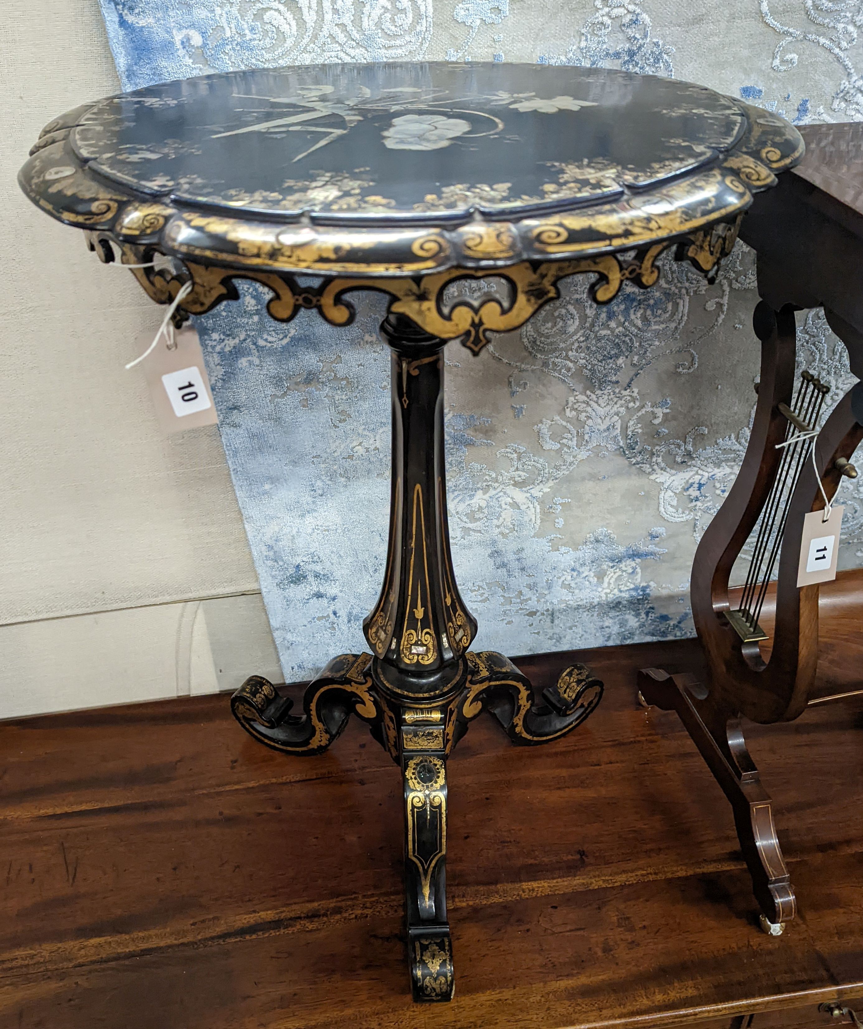 A Victorian mother of pearl inlaid gilt decorated circular tilt top papier mache tripod wine table, diameter 51cm, height 74cm